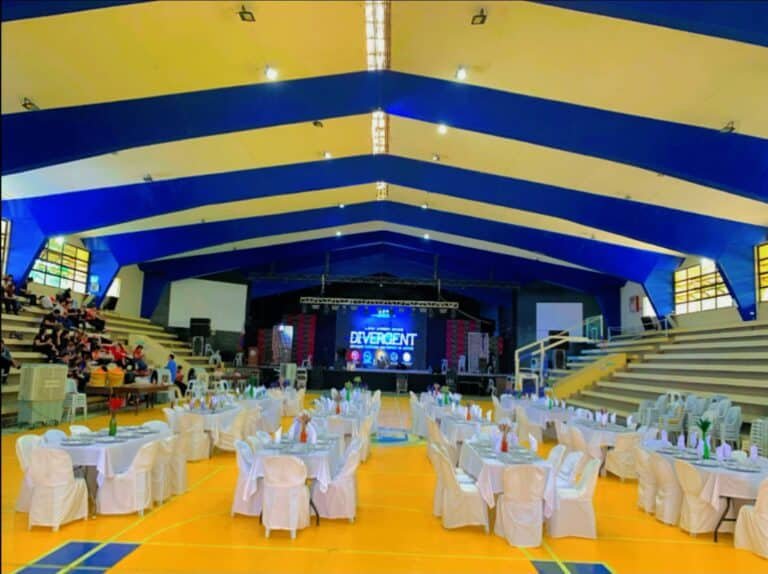 Cafe Esquinita banquet setup with white-draped tables for a large indoor event