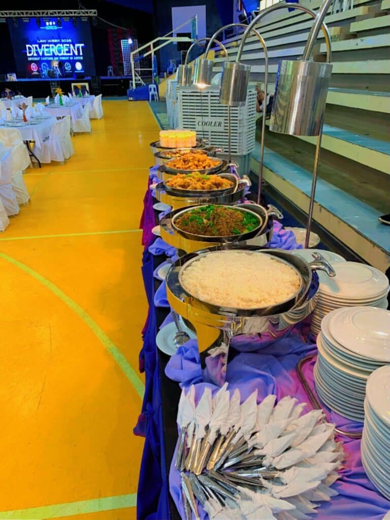 Cafe Esquinita catering buffet line with trays of food ready to serve