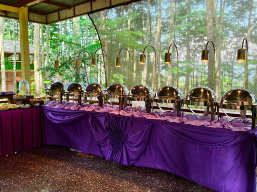 Cafe Esquinita catering buffet with chafing dishes set up for an outdoor event in Malaybalay City, Bukidnon