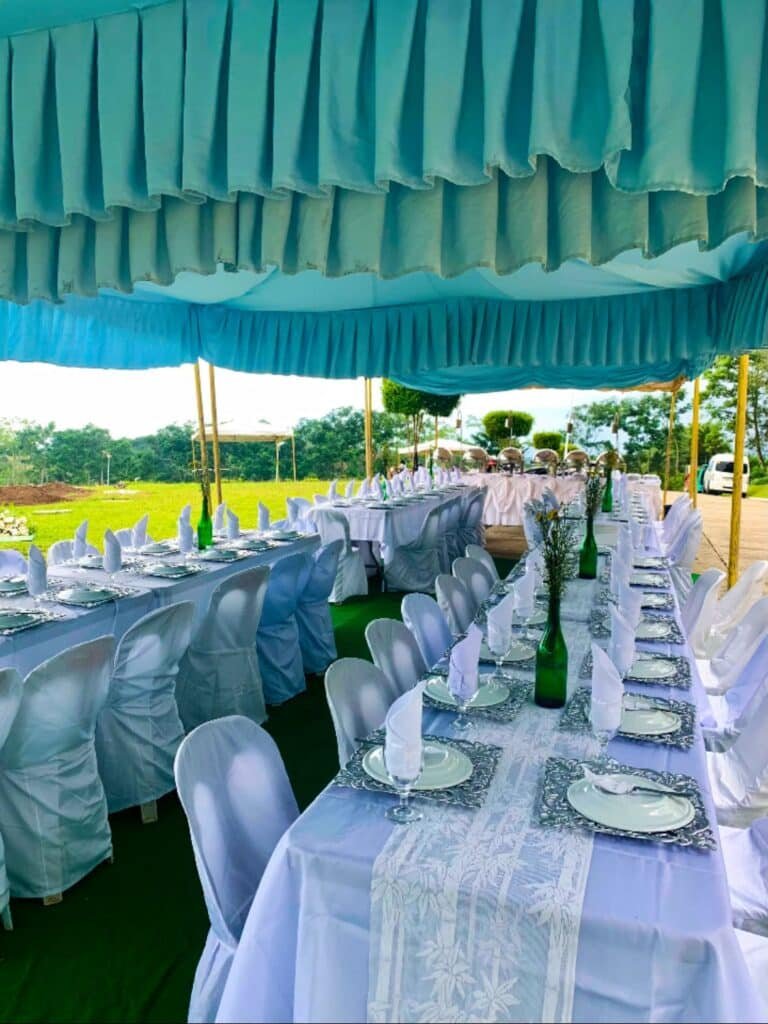 Cafe Esquinita long banquet tables set for guests under a tent