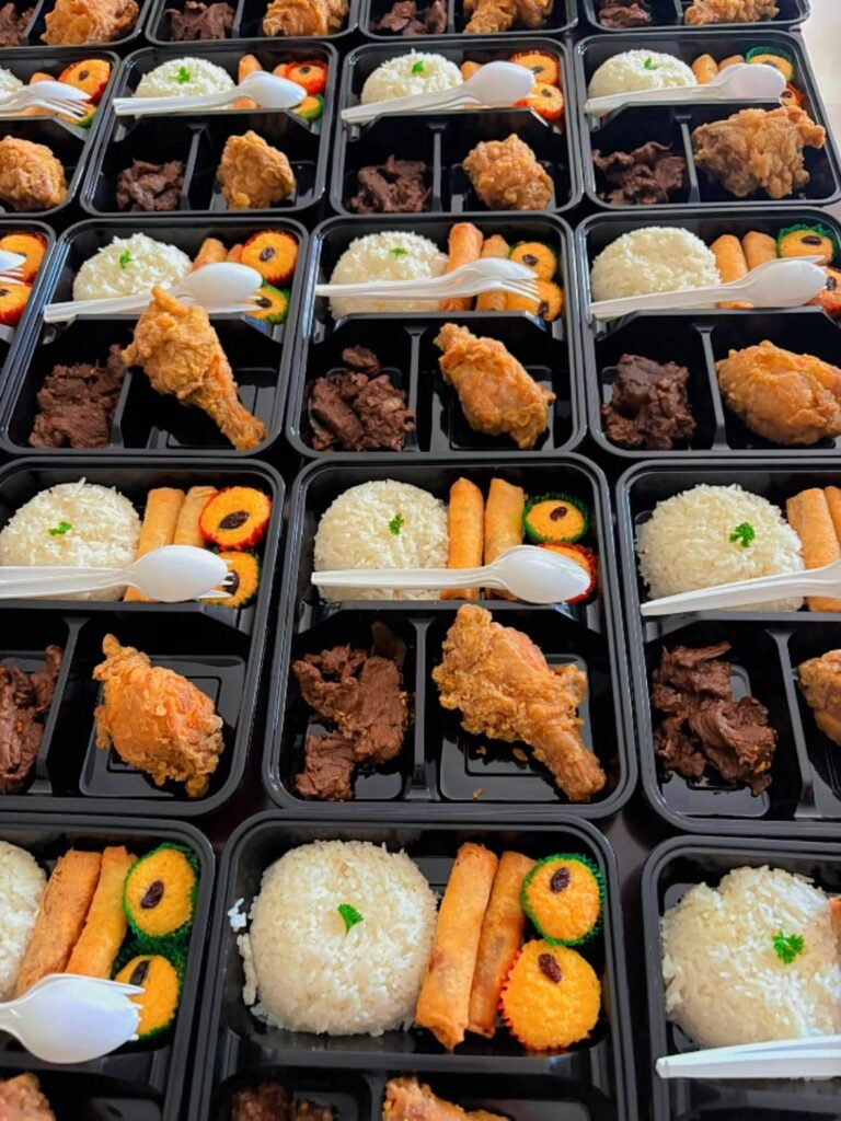 Cafe Esquinita packed meals with rice and fried chicken for a group order