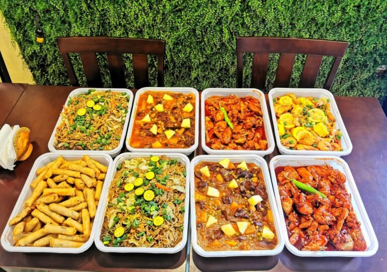 Party Platter Bundle from Cafe Esquinita: party trays of pancit, shanghai, menudo, chicken and shrimp dishes